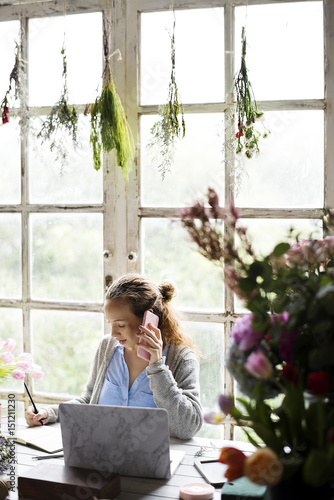Woman Talking on Mobile Phone in Flower Shop