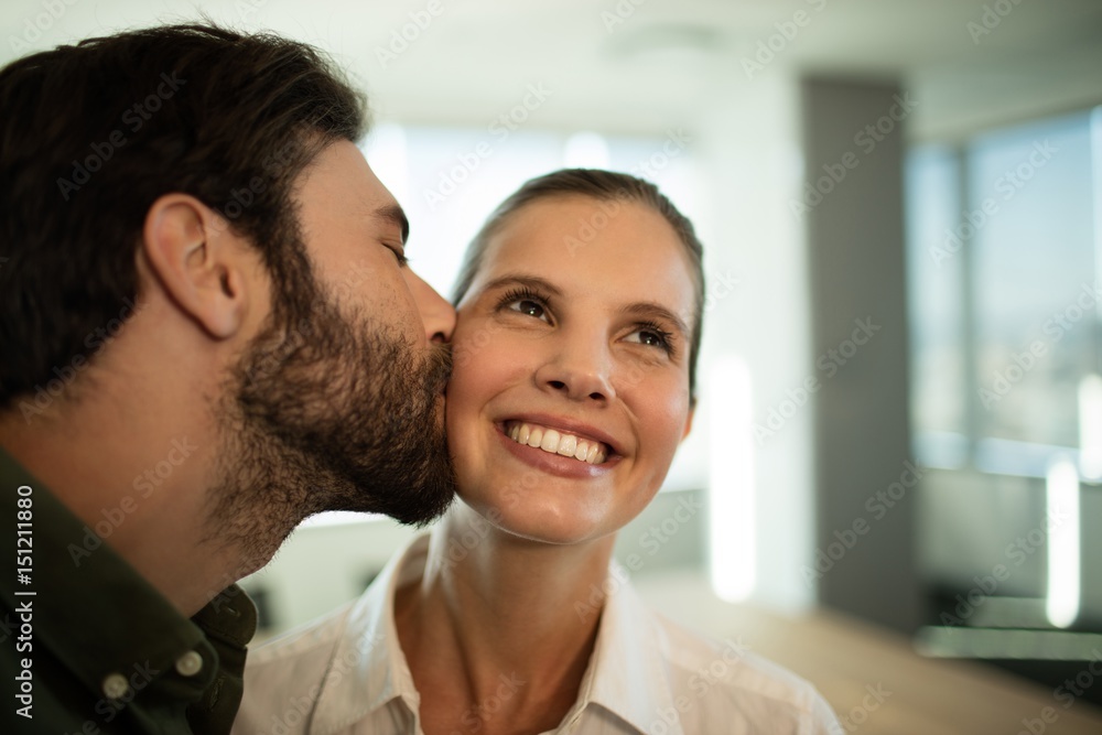Close up of businessman kissing businesswoman Close up of businessman kissing businesswoman
