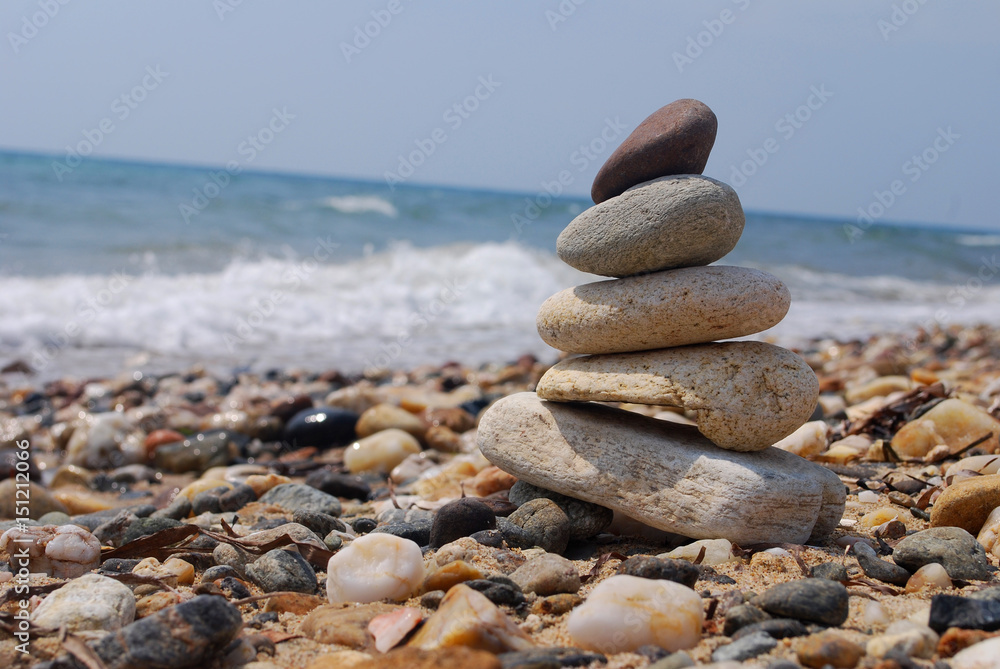 Stack of stones on the rocky beach. Concept of balance and harmony at the sea Stack of stones on the rocky beach. Concept of balance and harmony at the sea