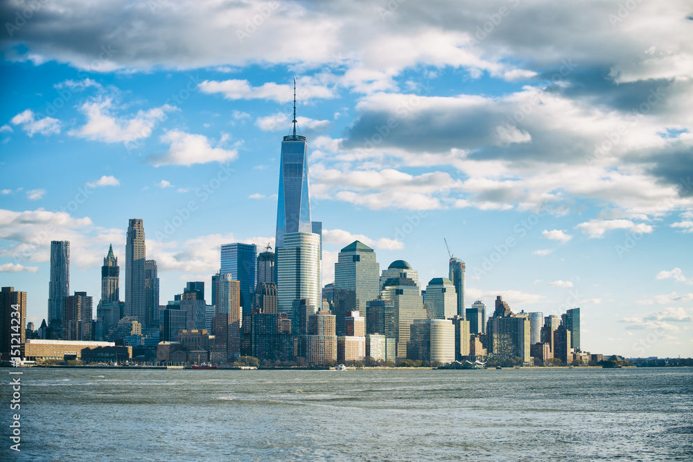 Fototapeta premium Blue sky view of the Downtown Manhattan New York City skyline from across the Hudson River in New Jersey