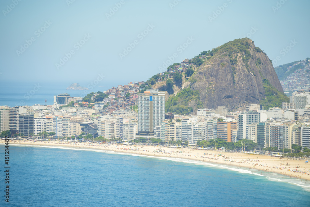 Bright scenic view of the golden crescent of Copacabana Beach with the city skyline of Rio de Janeiro, Brazil