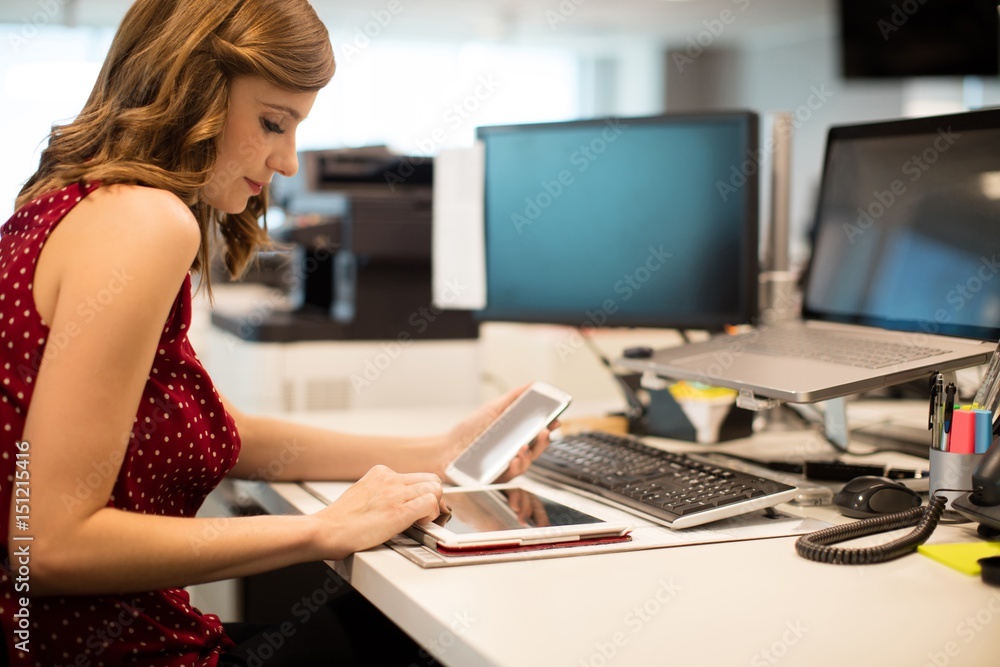 Young businesswoman using digital tablet in office Young businesswoman using digital tablet in office