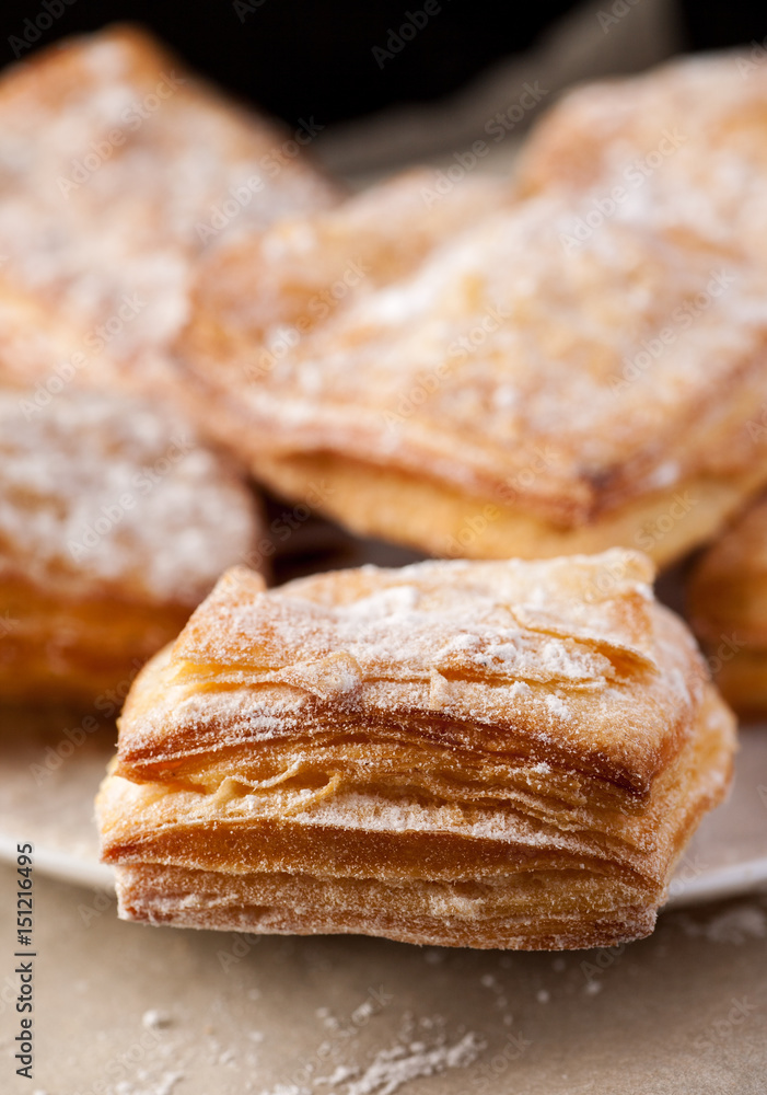 Macro shot of puff pastries in a white plate, vertical