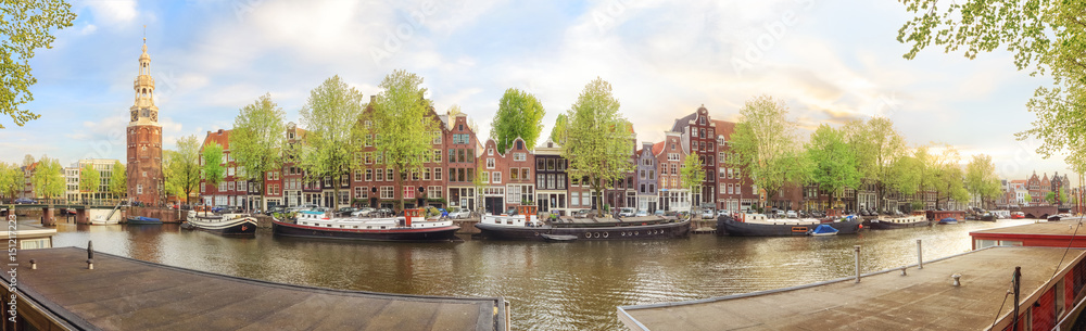 Fototapeta premium Canals of Amsterdam. Sunny panorama of old town district