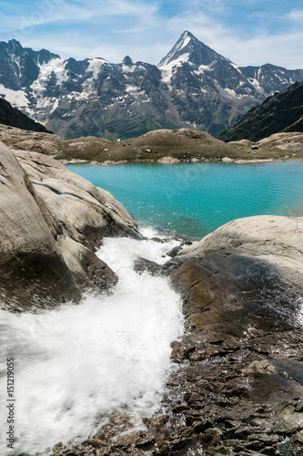 Gletscherbach mit See und Bietschhorn in den Schweizer Alpen photo