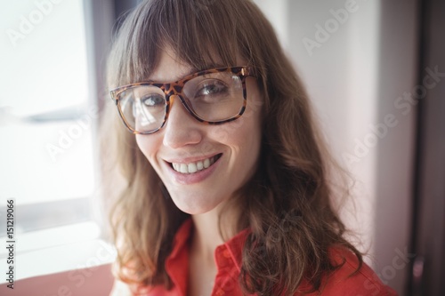 Smiling female interior designer standing in office