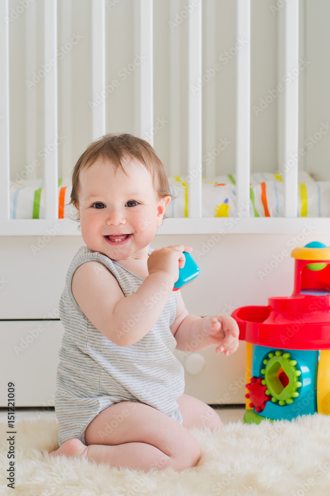 baby playing with educational toy in nursery baby playing with educational toy in nursery