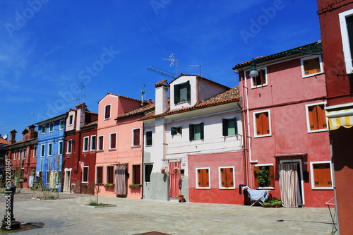Street with colorful buildings in Burano island, Venice, Italy.