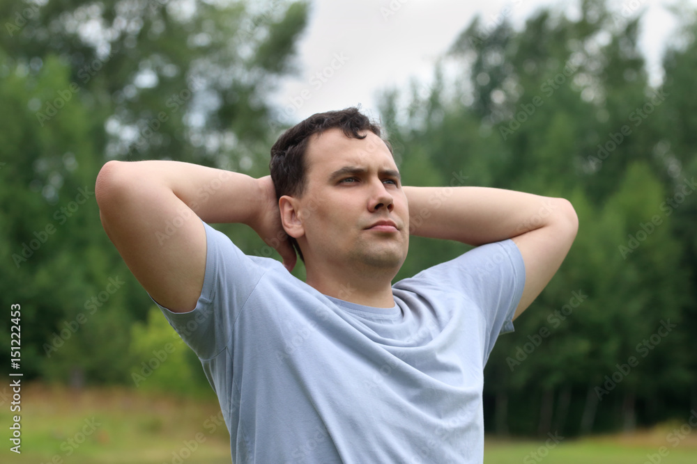 Young man poses outdoor at summer day, close up, shallow dof Young man poses outdoor at summer day, close up, shallow dof
