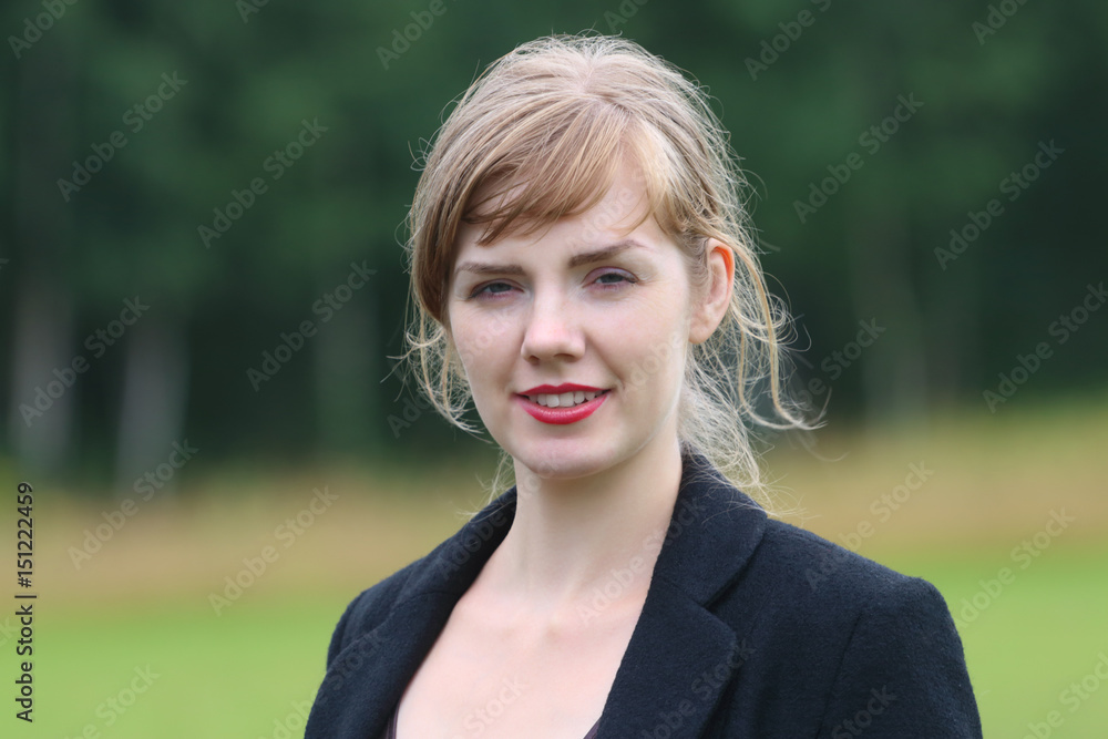 Young smiling woman poses outdoor at summer day, close up, shallow dof Young smiling woman poses outdoor at summer day, close up, shallow dof