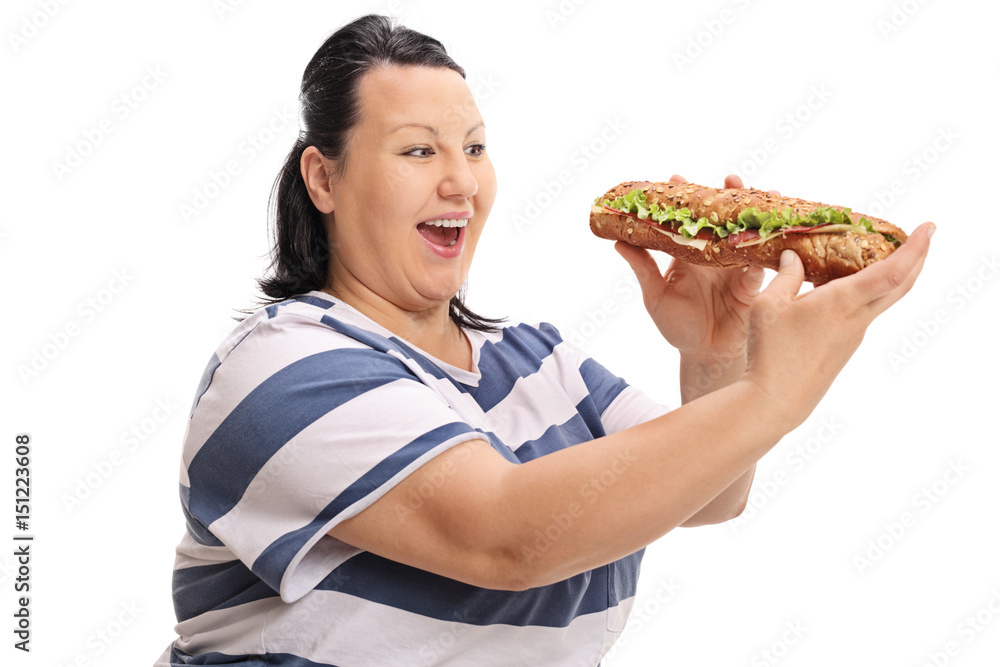 Happy overweight woman having a sandwich Happy overweight woman having a sandwich