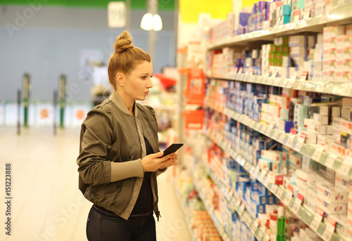 Woman choosing a dairy products at supermarket 