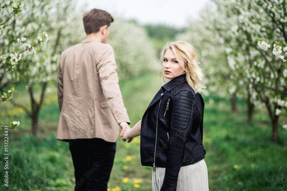 Fototapeta premium Young couple standing and holding hands