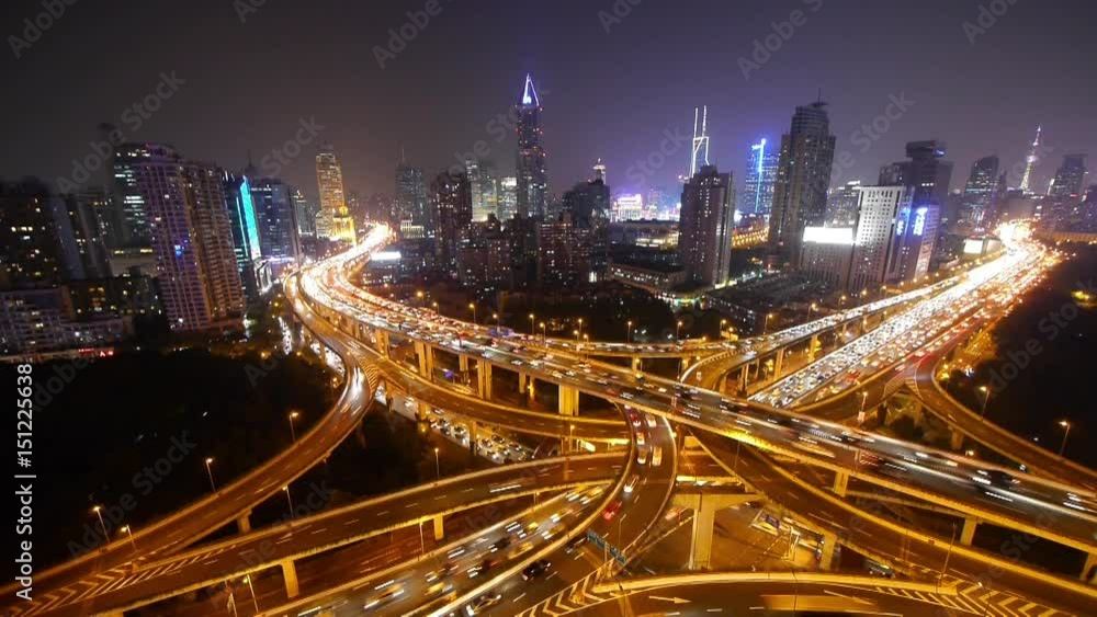 Aerial View of freeway busy city rush hour heavy traffic jam highway,shanghai Yan'an East Road Overpass interchange at night,driving racing by with streaking lights trail with super long exposures. Aerial View of freeway busy city rush hour heavy traffic jam highway,shanghai Yan'an East Road Overpass interchange at night,driving racing by with streaking lights trail with super long exposures.
