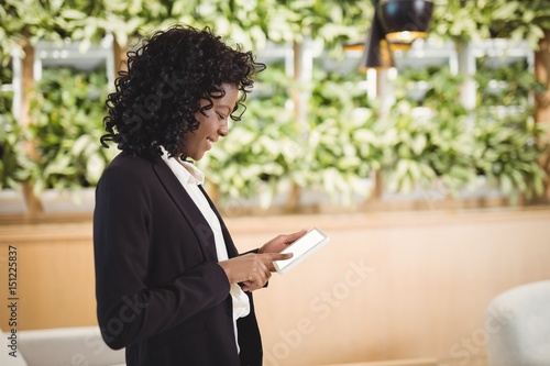 Smiling businesswoman using digital tablet