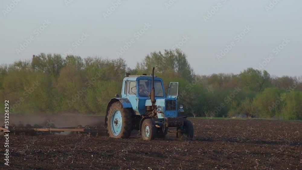Tractor Processing Field Farmer sowing a plowed field with old tractor Tractor Processing Field Farmer sowing a plowed field with old tractor