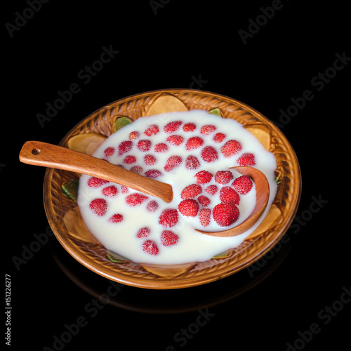 Ripe strawberry with milk in a bowl and spoon