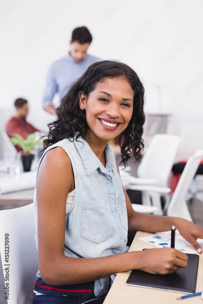 Fototapeta premium Portrait of happy businesswoman working in office