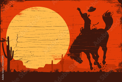 Silhouette of a cowboy riding a wild horse at sunset on a wooden sign, vector