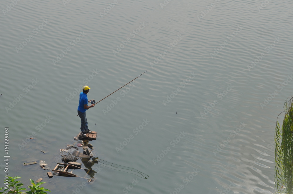Fisherman Standing on a Pier of Junk, West Lake, Hanoi, Vietnam