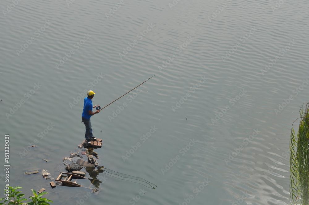 Fisherman Standing on a Pier of Junk, West Lake, Hanoi, Vietnam Fisherman Standing on a Pier of Junk, West Lake, Hanoi, Vietnam