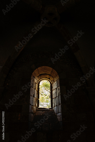 Small arched window inside thick mediaval castle wall