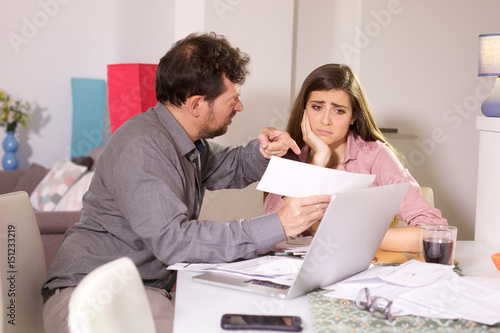 Husband angry with wife showing high bill