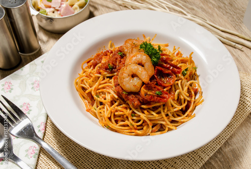 Seafood pasta Spaghetti with Clams, Prawns, Seafood Cocktail in set have salad on wood table