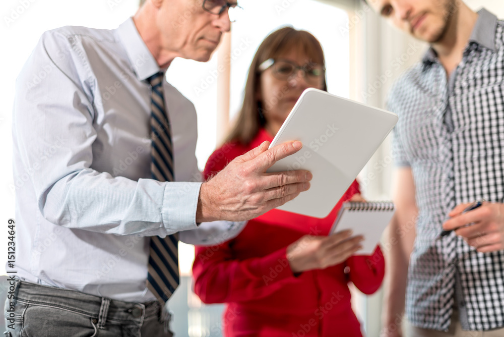 Business people in meeting working on tablet Business people in meeting working on tablet