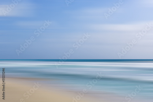 Beach view with motion blur effect. Calm and pastel coloured wallpaper. Copy space.