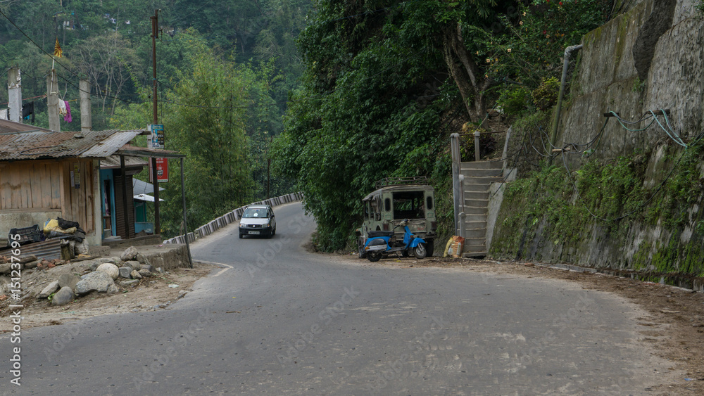 Car passing by a hilly street