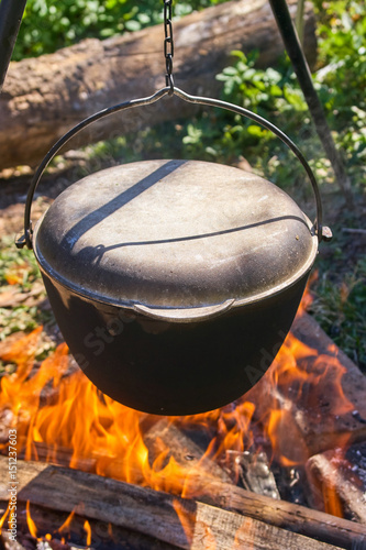 Pilau in cauldron on fire
