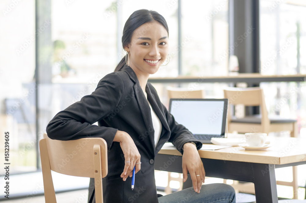 Businesswoman working on desk with laptop computer,Business woman in professional look and happy smiling