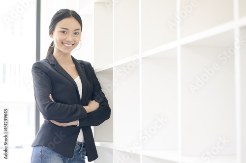 Businesswoman cross one's arm,Professional woman is smiling in black suite.
