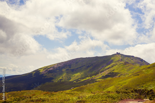 Silhouette of a mountain observatory on top of a green ridge © sanechka