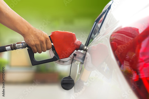 Refuel car with petrol, refueling car at the refuel station photo