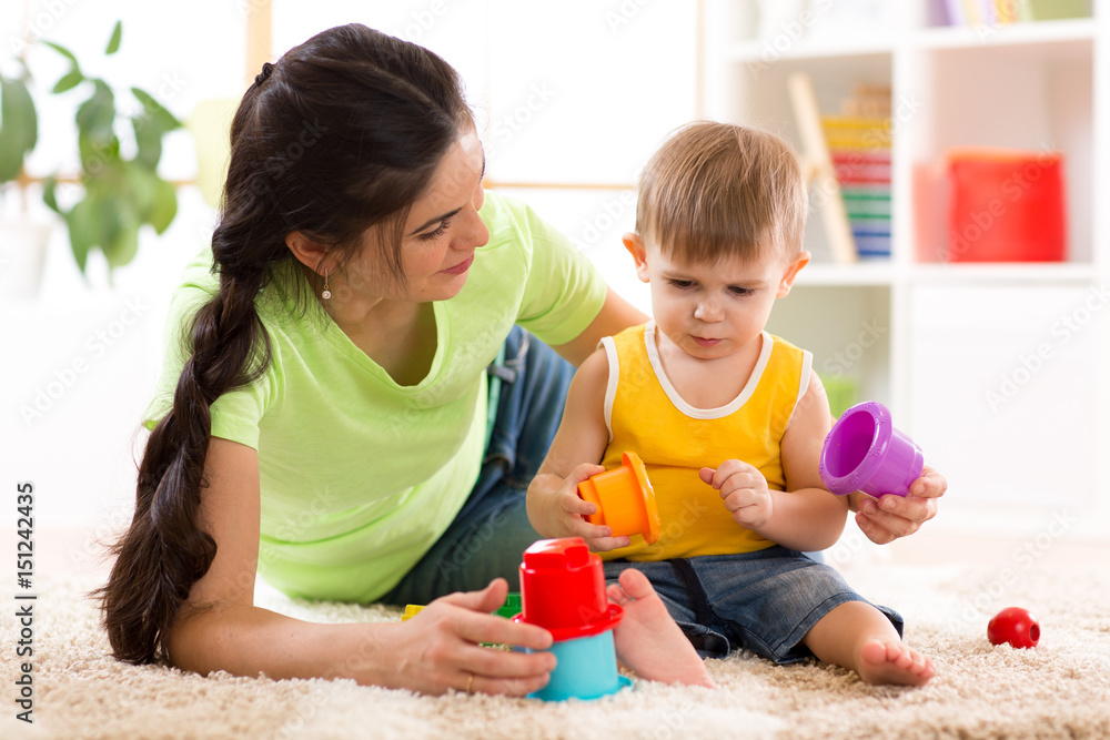 cute mother and child boy play together indoors at home cute mother and child boy play together indoors at home