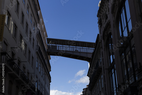 silhouette of a bridge connecting buildings. Blue sky. Urban background. City.