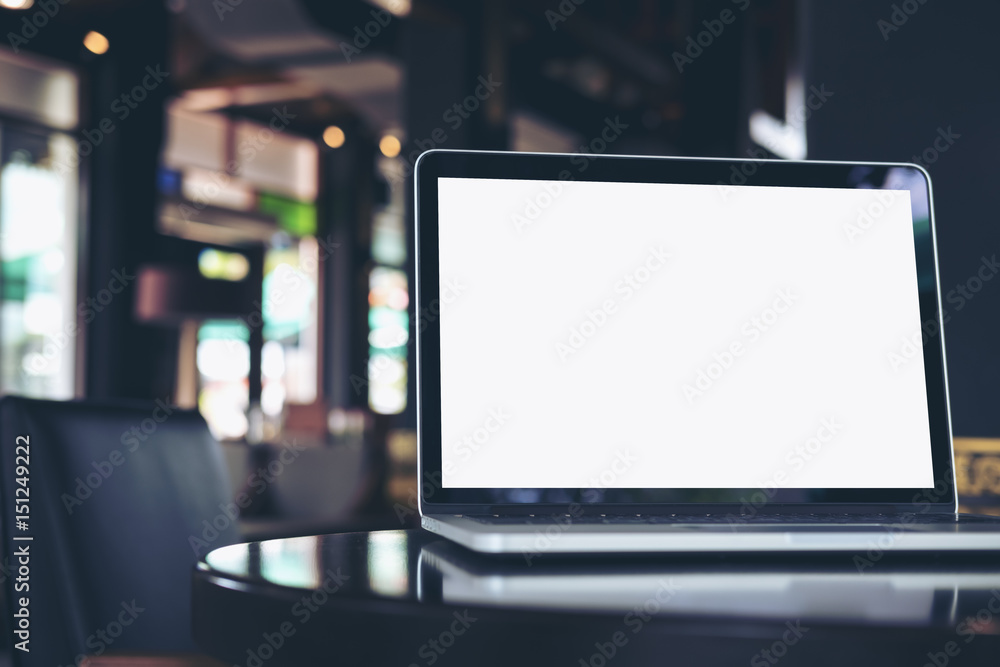 Mockup image of laptop with blank white screen on wooden table in coffee shop Mockup image of laptop with blank white screen on wooden table in coffee shop
