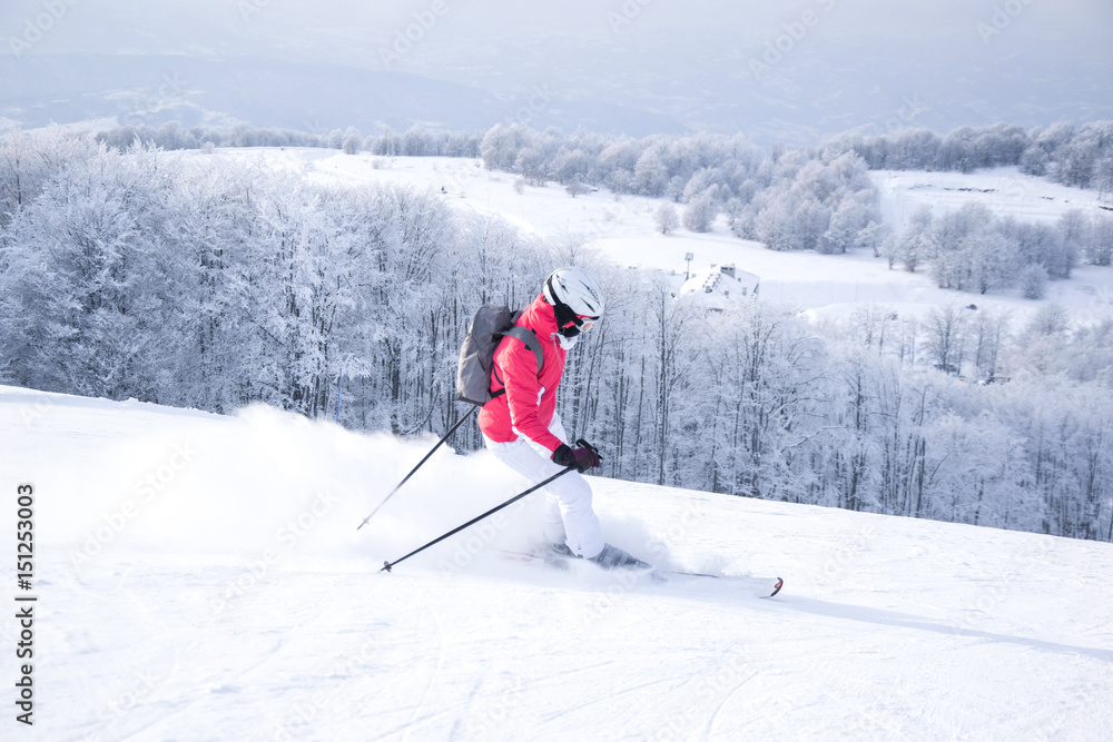 Woman skiing in mountain ski resort