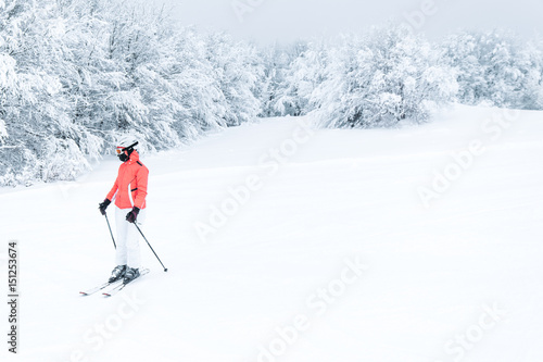 Woman skier skiing on mountain slope 