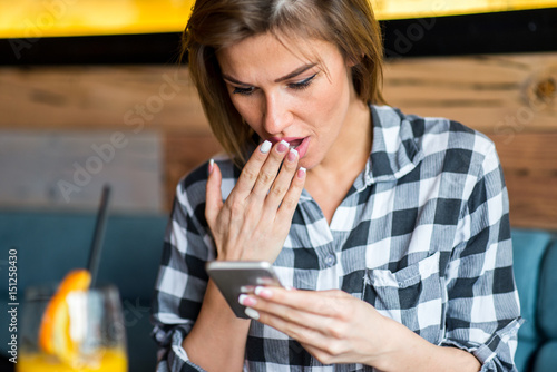 Beautiful young woman using cell telephone while enjoying her free time in cafe