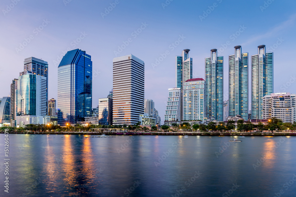 Cityscape in Benjakitti public park in Bangkok downtown in the twilight. Cityscape in Benjakitti public park in Bangkok downtown in the twilight.