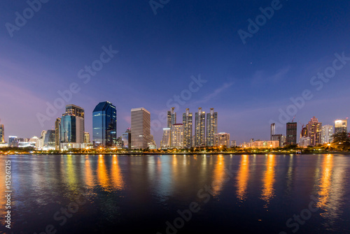 Scenic view of Public park (Benjakitti park) in downtown Bangkok with buildings background in evening time. © mrcmos