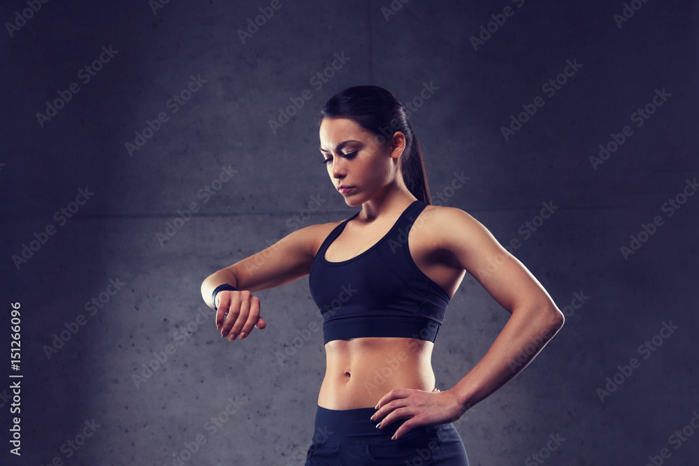 young woman with heart-rate watch in gym young woman with heart-rate watch in gym