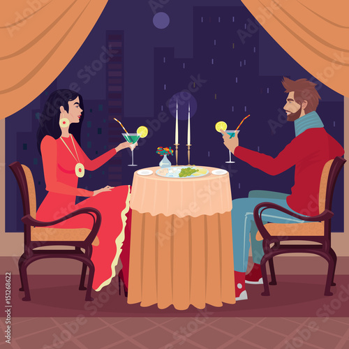 Young and attractive girl and guy sitting at restaurant table with raised glasses of drinks in the evening. Toast for the occasion. Celebration or rendezvous concept