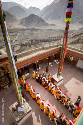 Buddhist monks are starting annual Angchok festival in the courtyard of their monastery in the Indian Himalaya. Chemrey, Ladakh, India