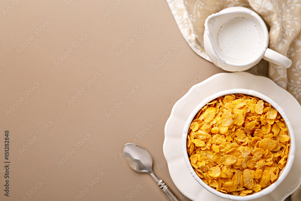 Flat lay bowl with healthy breakfast and milk jug. View from above. Spoon, cereals, milk. Top view. Copy space Flat lay bowl with healthy breakfast and milk jug. View from above. Spoon, cereals, milk. Top view. Copy space
