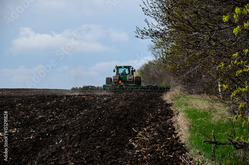 Tractor cultivating field