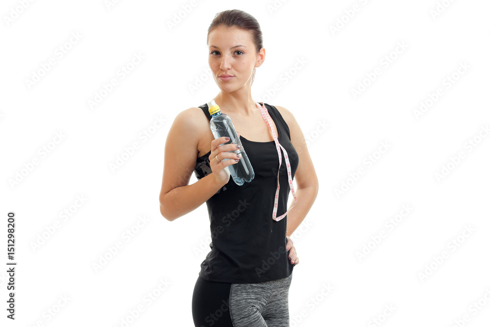 beautiful fitness girl posing on camera and holding a water bottle beautiful fitness girl posing on camera and holding a water bottle